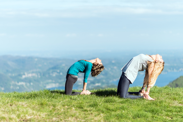 Yoga exercises in nature on mountains: camel pose